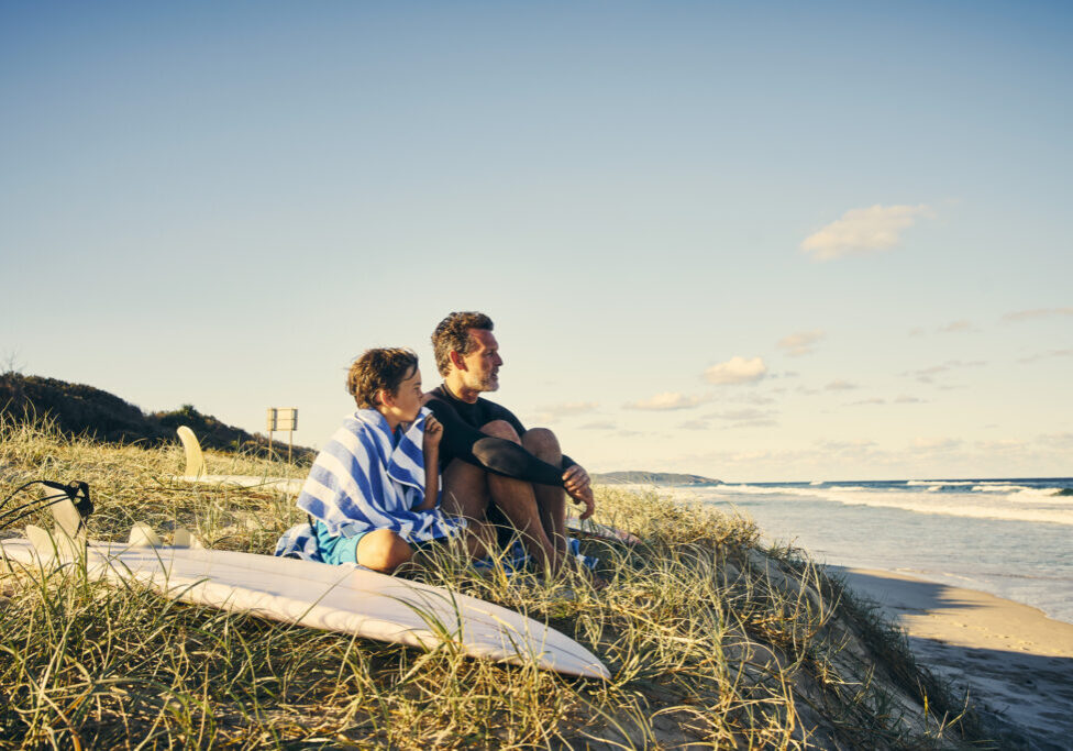 Watching the waves together Shot of a father and son enjoying a day outdoors
